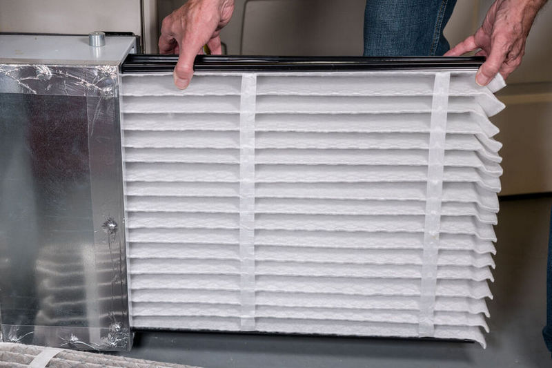 inserting an air filter in HVAC furnace